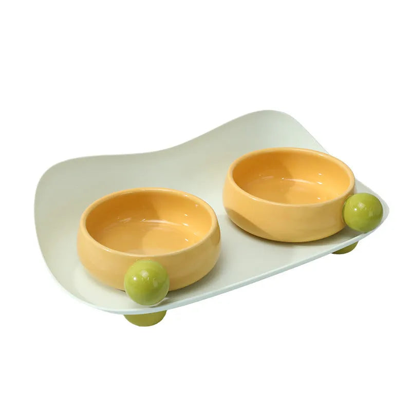 Elevated ceramic pet feeding bowl set with two bowls on raised platform