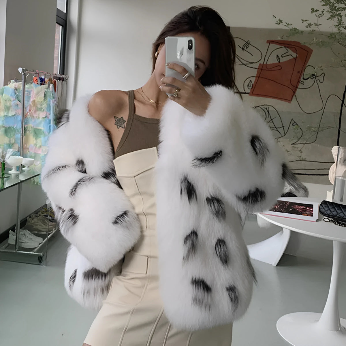 Black and white faux fur women's coat with short length and regular sleeves