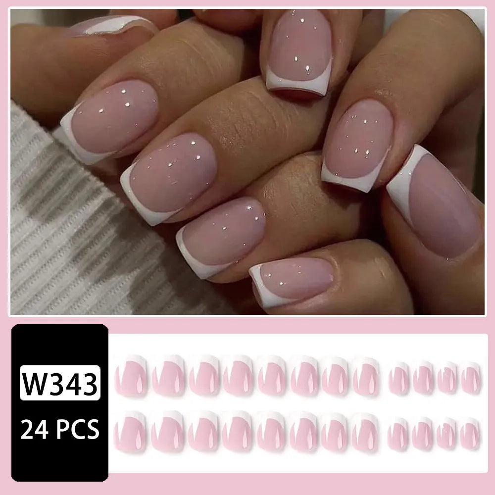 24 white false nail tips with a black and white plaid pattern, arranged on a card.