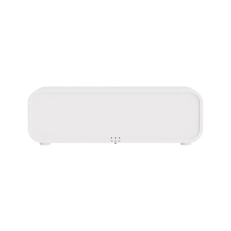 Black and white USB aroma diffuser with remote control and colour-changing lights on a wooden surface