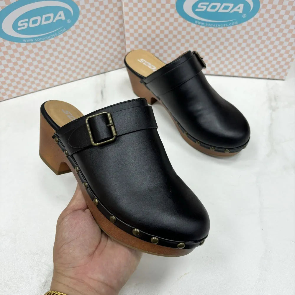 Black chunky heel slippers with closed toe, rivet detailing, and round head design