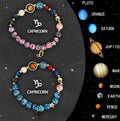 Two natural stone beaded bracelets with zodiac sign charms on a wooden surface.