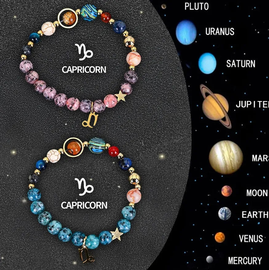 Two natural stone beaded bracelets with zodiac sign charms on a wooden surface.