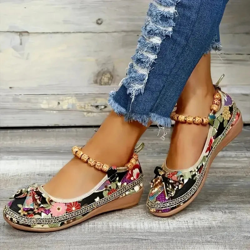 Women's black ethnic style platform sandals with cloth upper and elastic band fastening.