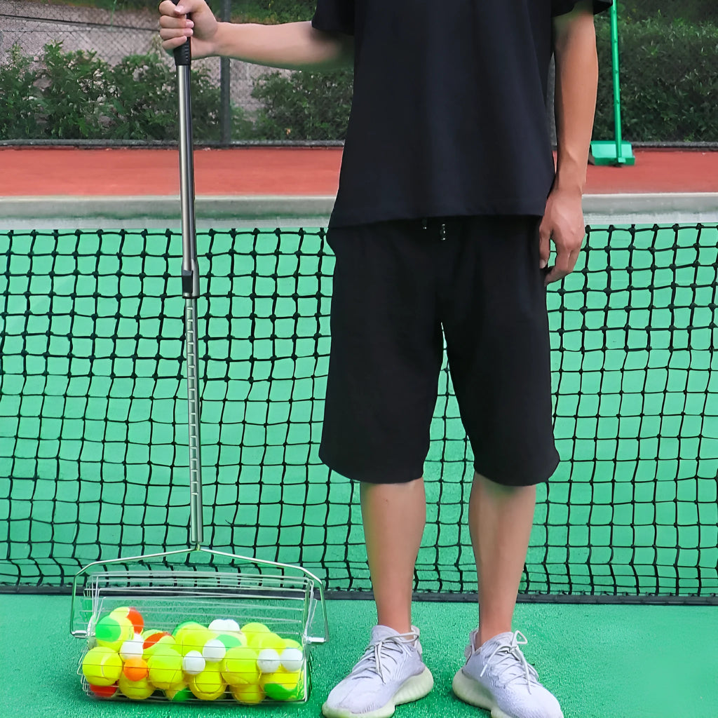 Stainless steel tennis ball picker roller with adjustable handle on tennis court