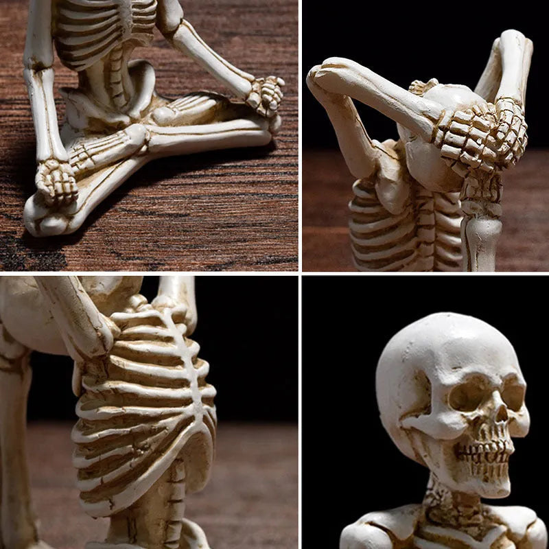 Detailed resin Halloween ornament of a yoga-posing skeleton skull on a desktop.