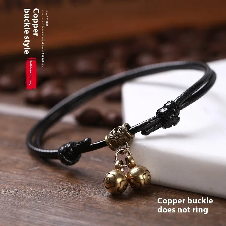 Nylon dog collar with brass bell shown in black rope colour, adjustable size 8 to 17 cm