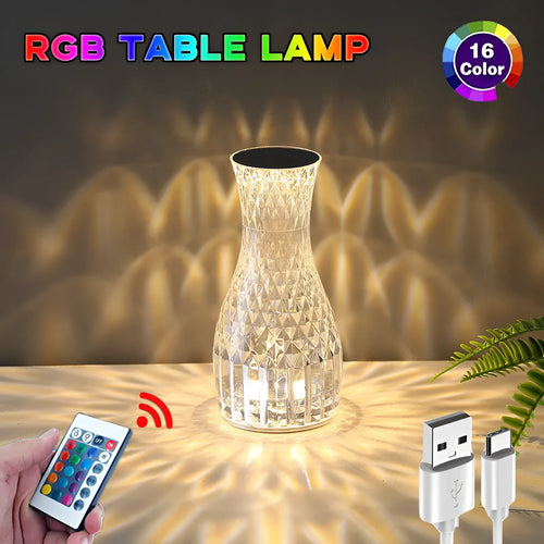 Transparent vase-shaped crystal LED table lamp with multi-colour lights on a wooden table.