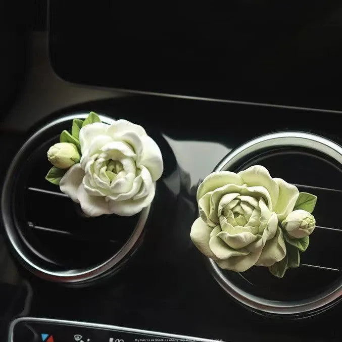 Jasmine-scented car air freshener with gypsum base clipped to vehicle vent