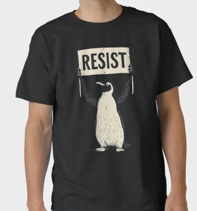 A loose-fit black cotton t-shirt with short sleeves and a round neck on a hanger.