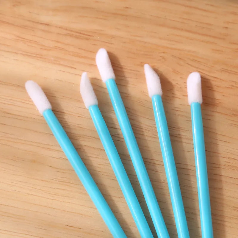 Disposable lip brushes with flocked tips and black handles in multiple colours