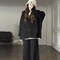 A knitted zipper cardigan and wide-leg trousers two-piece set in a solid colour on a model.