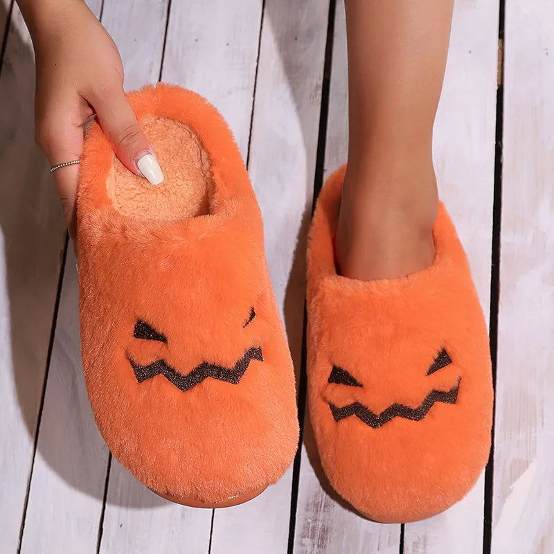 Orange Halloween pumpkin-themed plush slippers with a coral velvet upper and non-slip sole.