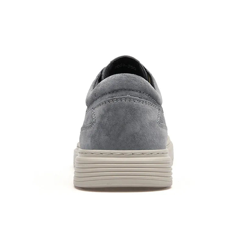 Grey and sand coloured low-top casual skate shoes with pigskin leather upper and rubber sole.