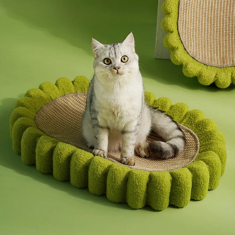 Green oval-shaped cat scratcher pad with sisal surface serving as a scratching area and cat bed.