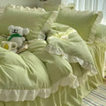 Mori style solid colour linen four-piece bedding set with quilt cover, sheet, and pillowcases on a bed.