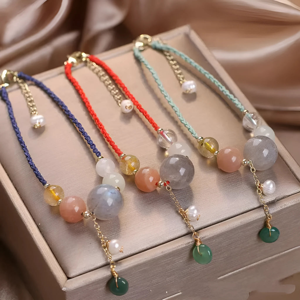Hand-woven crystal and sequin bracelet with metal buckle clasp in red, blue, or green.