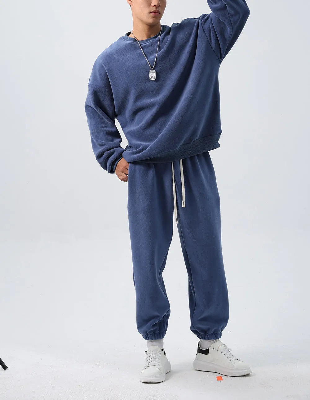 Men's polar fleece sports suit showing loose long sleeve coat and padded trousers in army green.