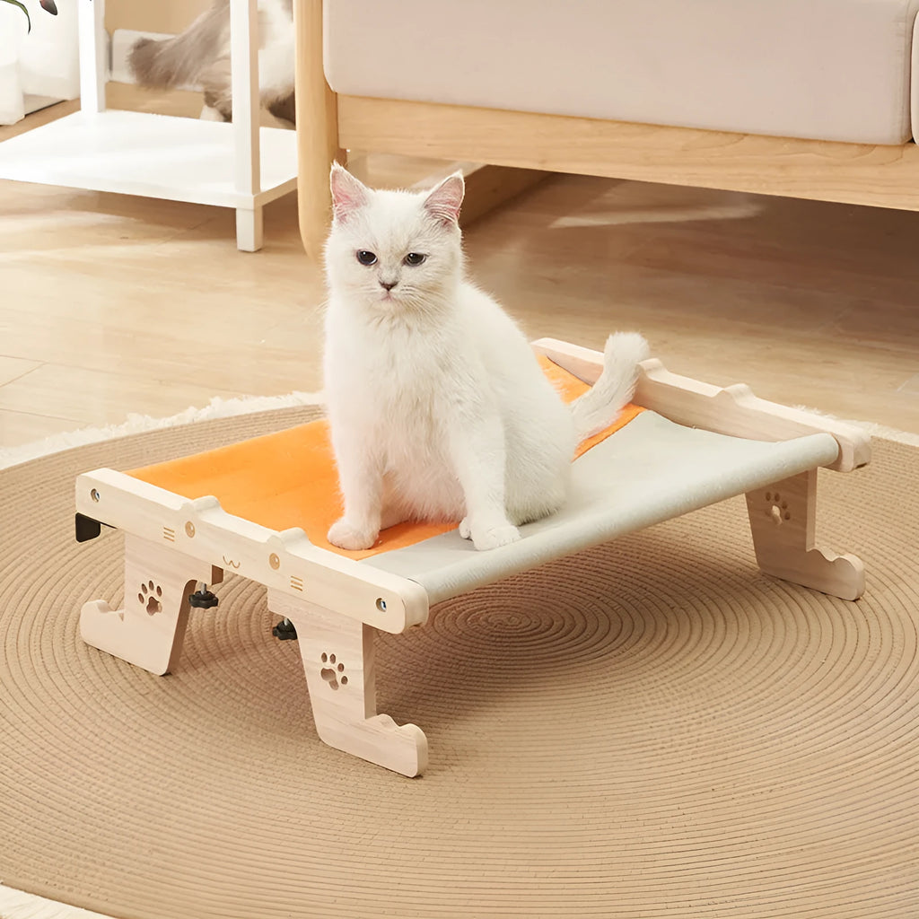 Wooden cat hanging bed with fabric hammock installed on balcony railing