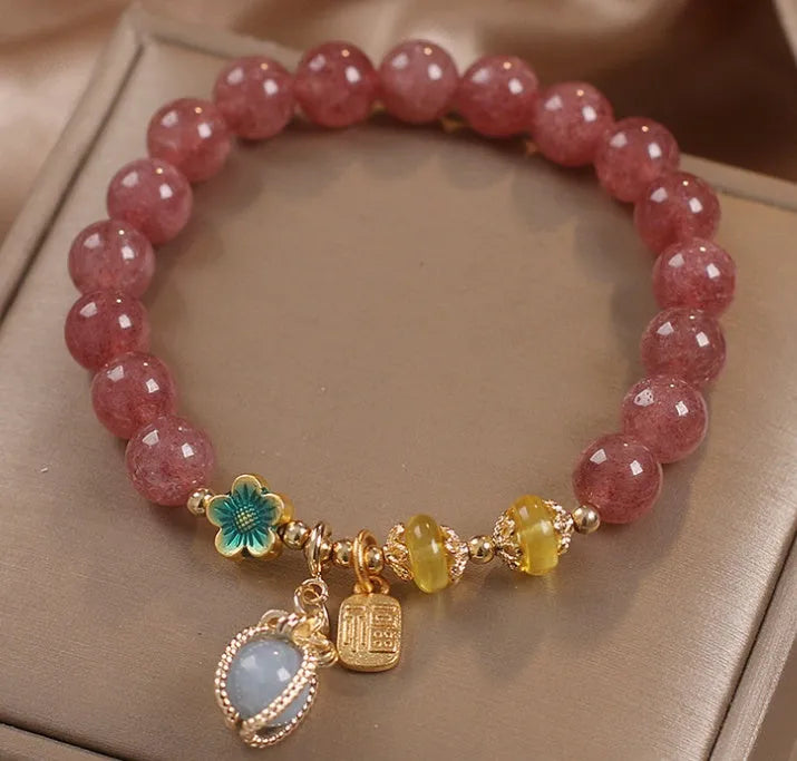 Red women's bracelet with strawberry quartz beads, alloy metal, and rhinestone detailing