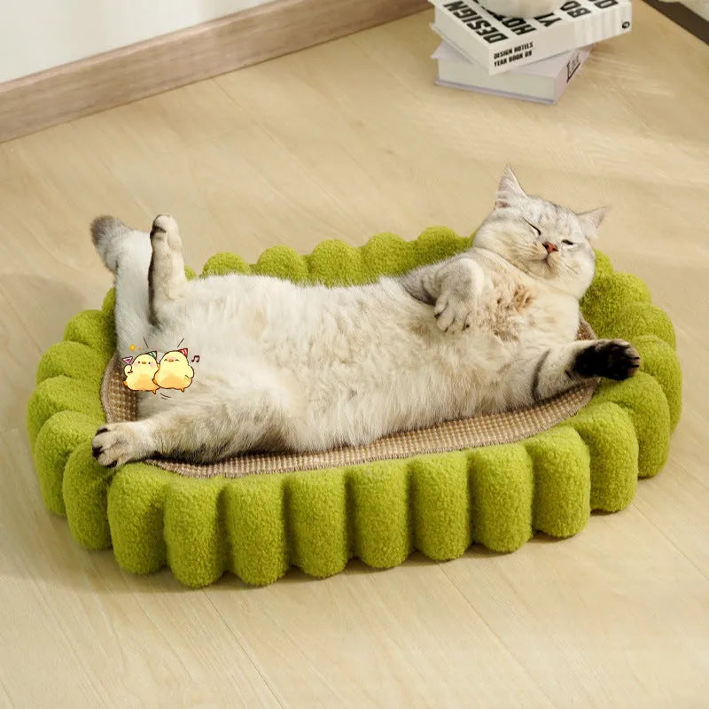 Green oval-shaped cat scratcher pad with sisal surface serving as a scratching area and cat bed.