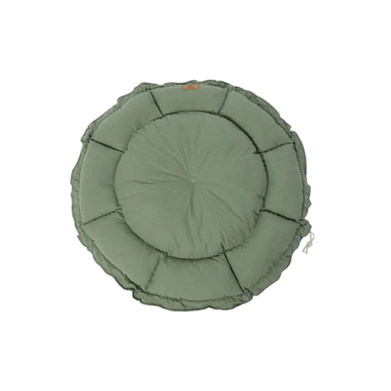 Grey reversible donut-shaped pet bed for cats and small dogs on a wooden floor.