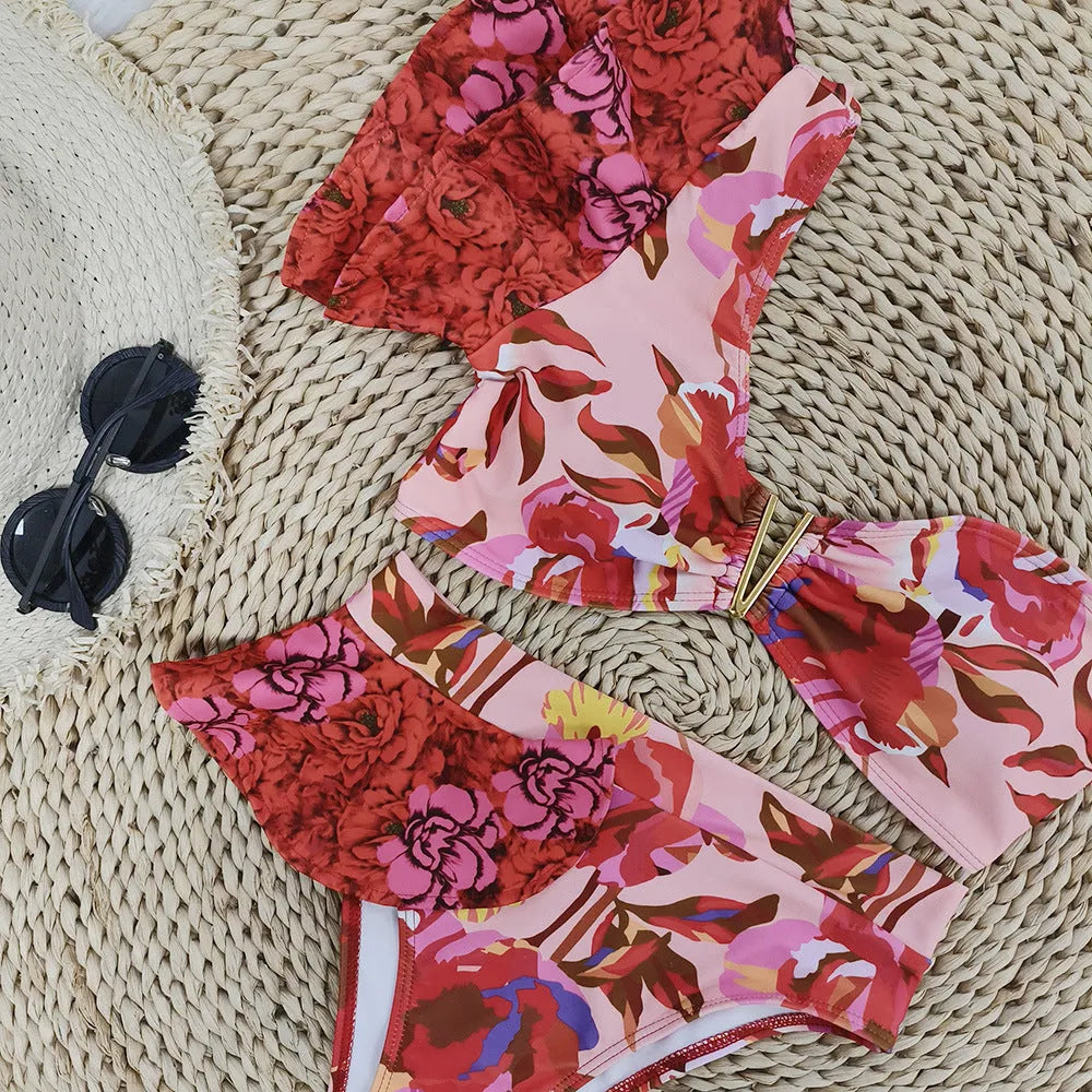 Pink floral print women's one-shoulder ruffled swimsuit with high-waist bikini briefs.