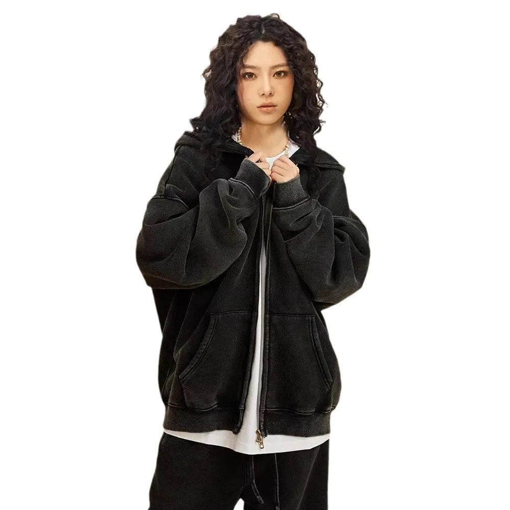 Man wearing a washed black fleece-lined hooded cardigan with a double zipper front.