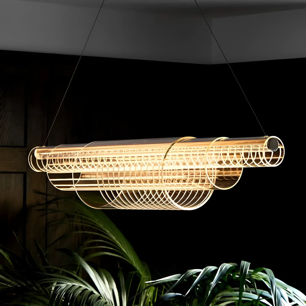 Modern clear glass and iron LED pendant light hanging at three different lengths.