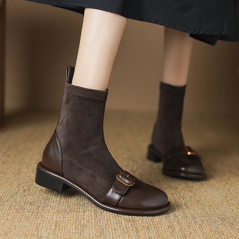 Women's black low heel Martin ankle boots with lace-up front and buckle stitch detail on a white background.