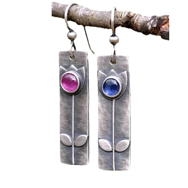 Antique finish red sapphire earrings with geometric oval shape and electroplated metal construction