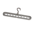 Modern plastic nine-hole folding hanger for trousers in green, blue, pink, beige, or grey.