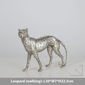Leopard-shaped resin home ornament in American Leopard colour on wooden surface