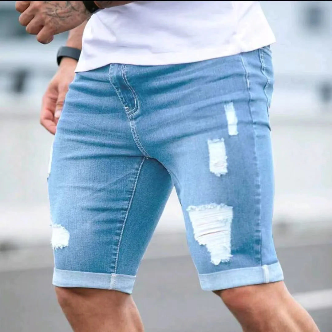 Men's sky blue denim shorts with multi-hole distressed design showing low waist and straight cut