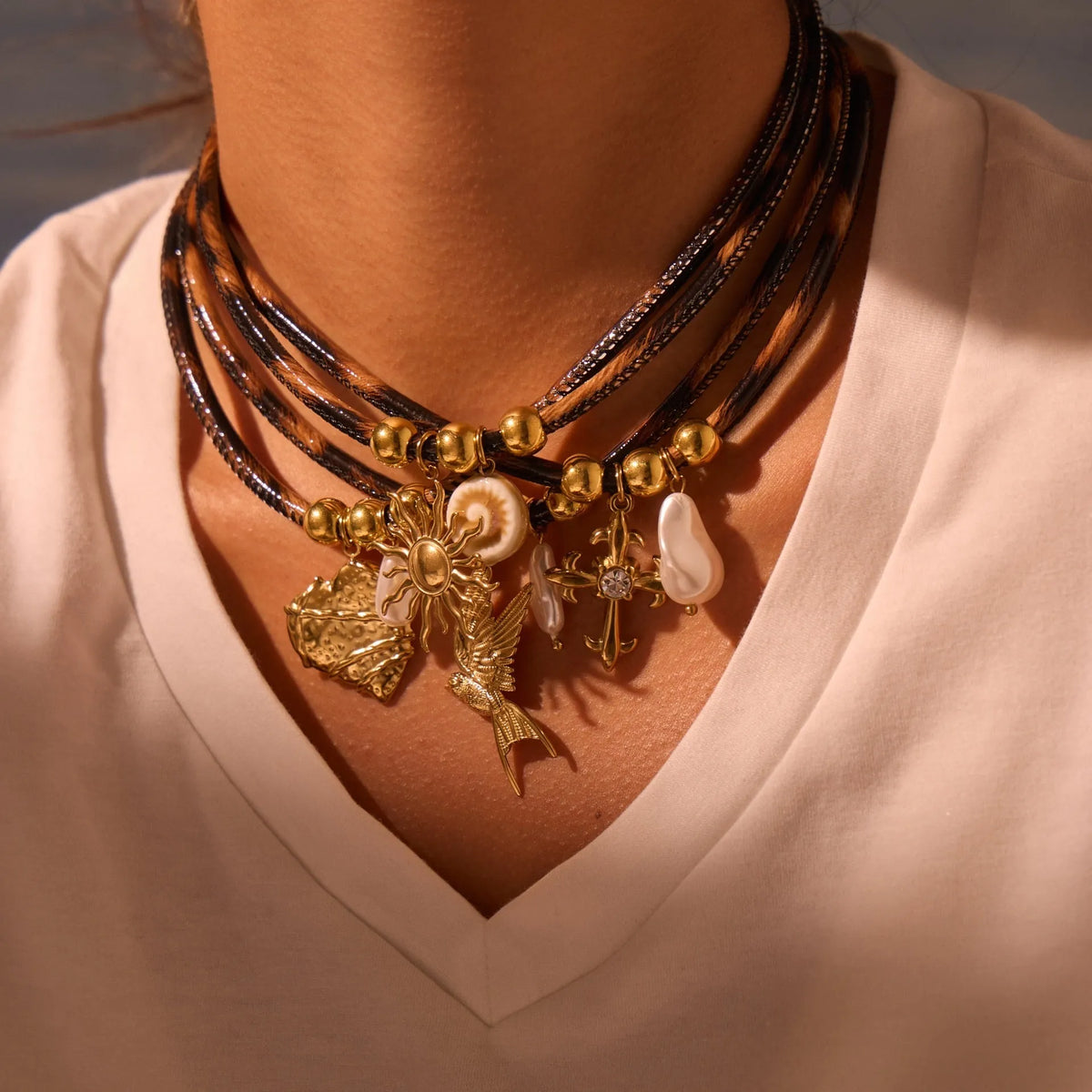 Leopard print geometric pendant on stainless steel necklace with gold-plated accents