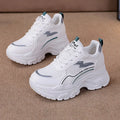 White women's dad shoes with cross shoulder straps and lace-up front on a rubber sole.