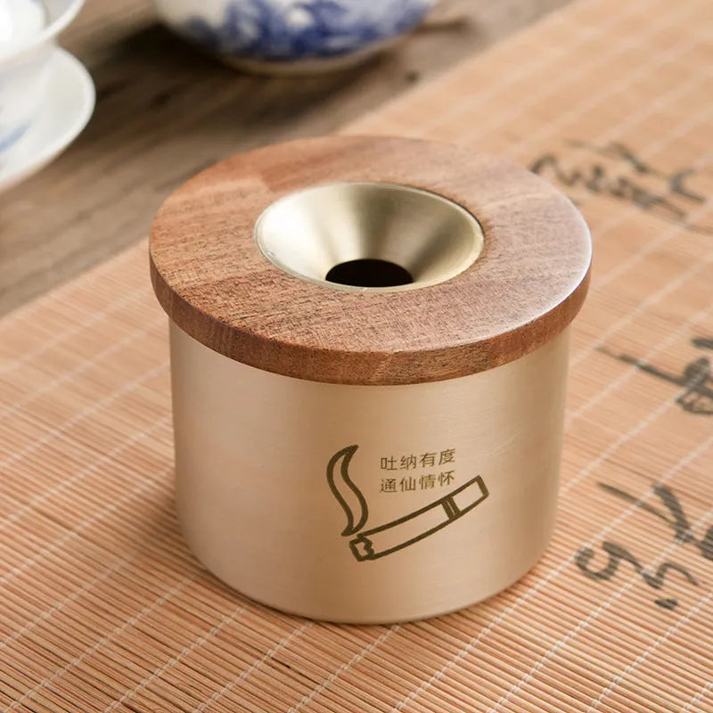 Brass ashtray with wooden lid featuring centre hole design