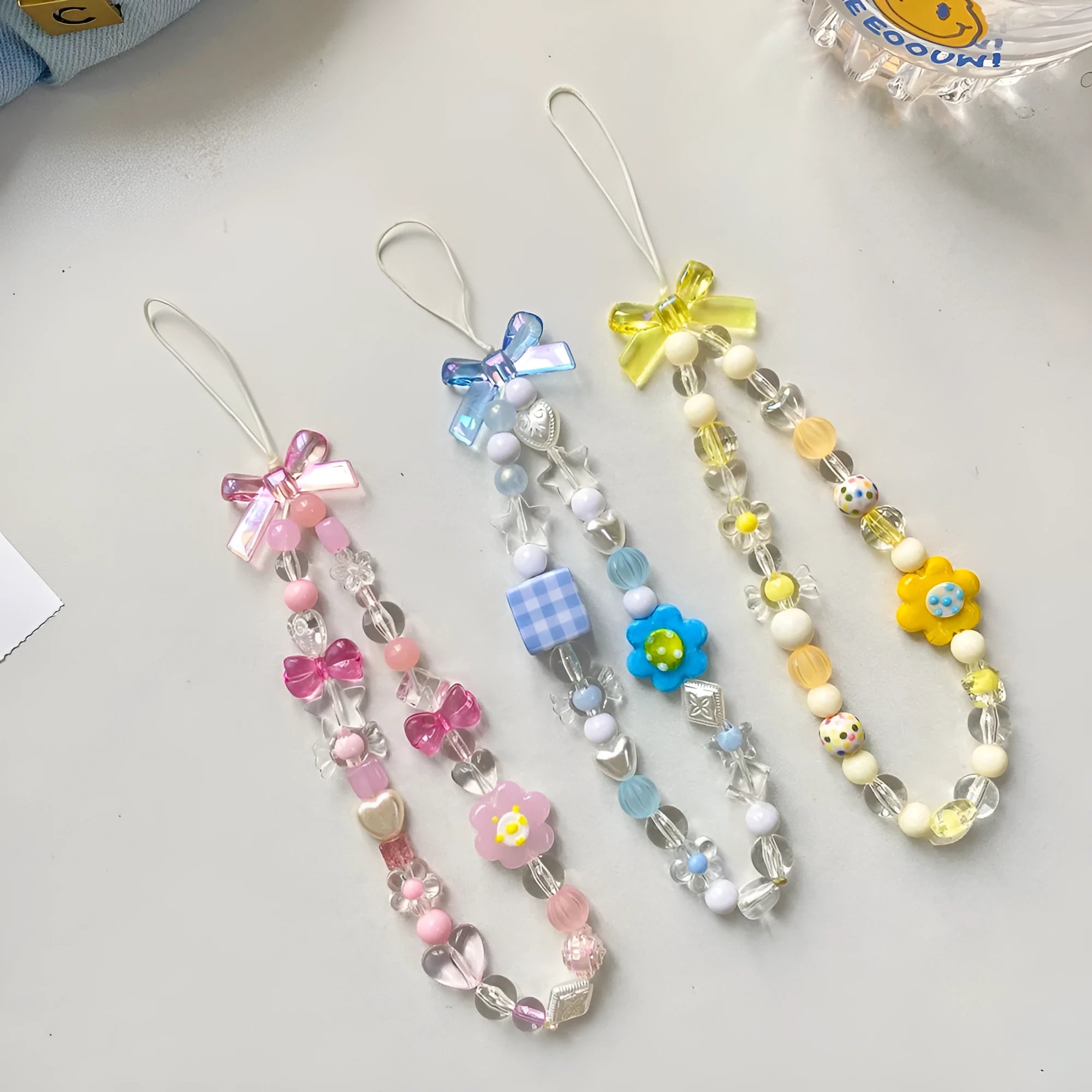 Beaded flower mobile phone lanyard with plastic resin decoration in blue, pink or yellow colours