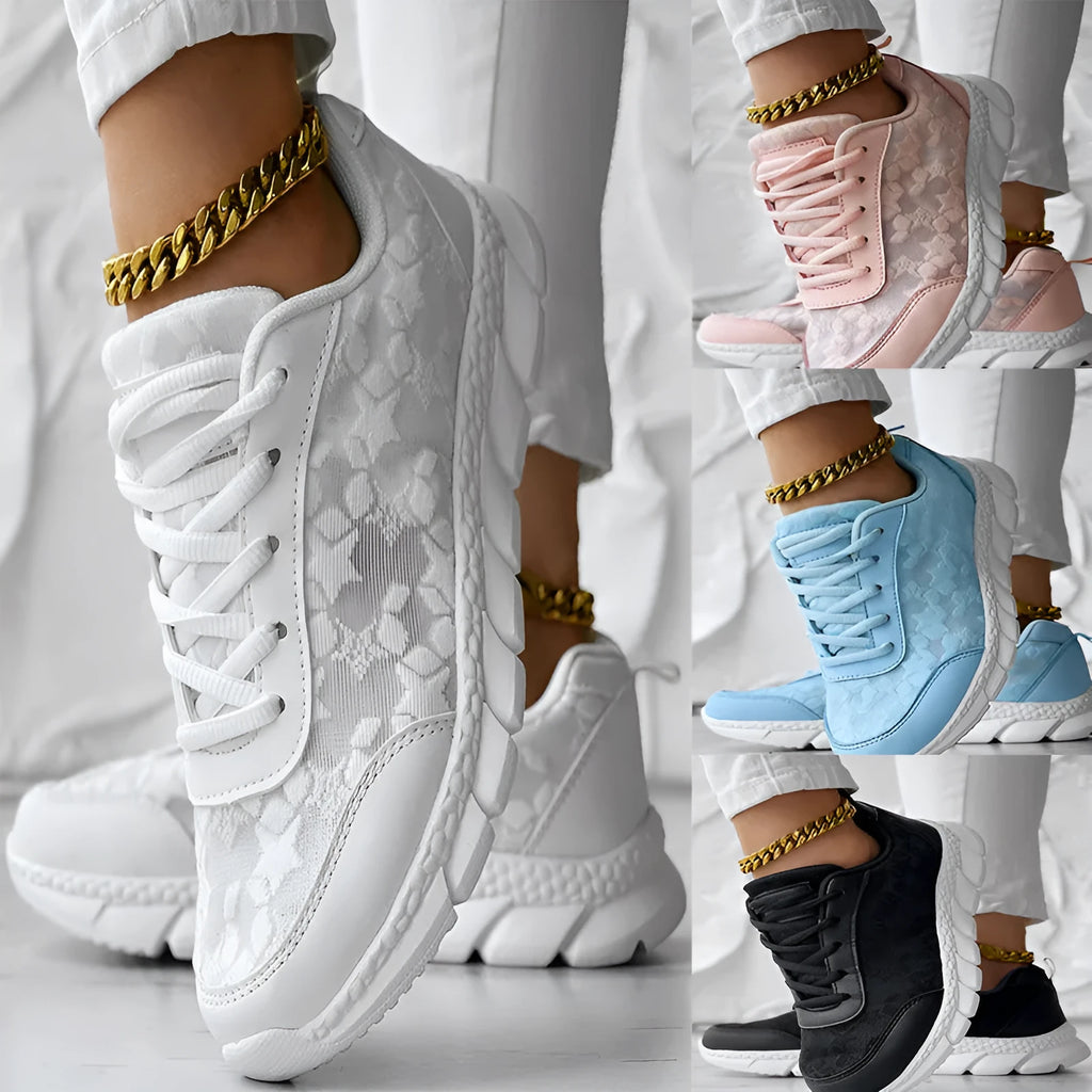 Women's white canvas casual sports shoes with soft bottom and flat heel on a light background.