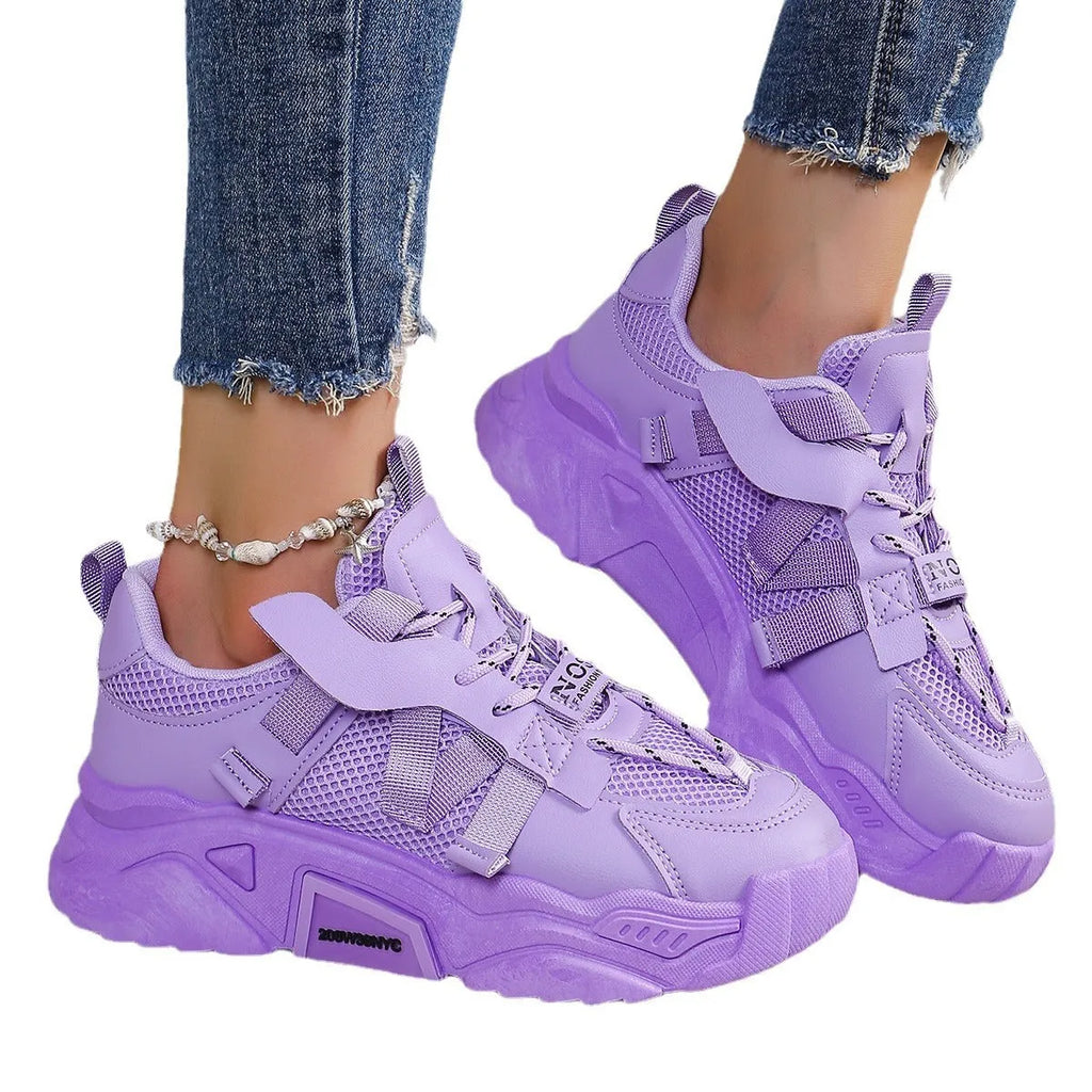 Women's purple platform mesh sports trainers with animal pattern and lace-up front on a white background.