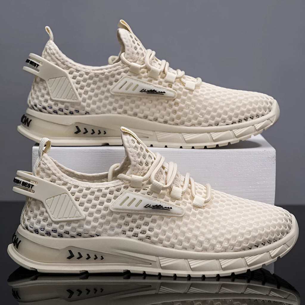 Men's beige casual sneaker with synthetic leather upper and mesh detailing, flat low-heel profile on a white background.
