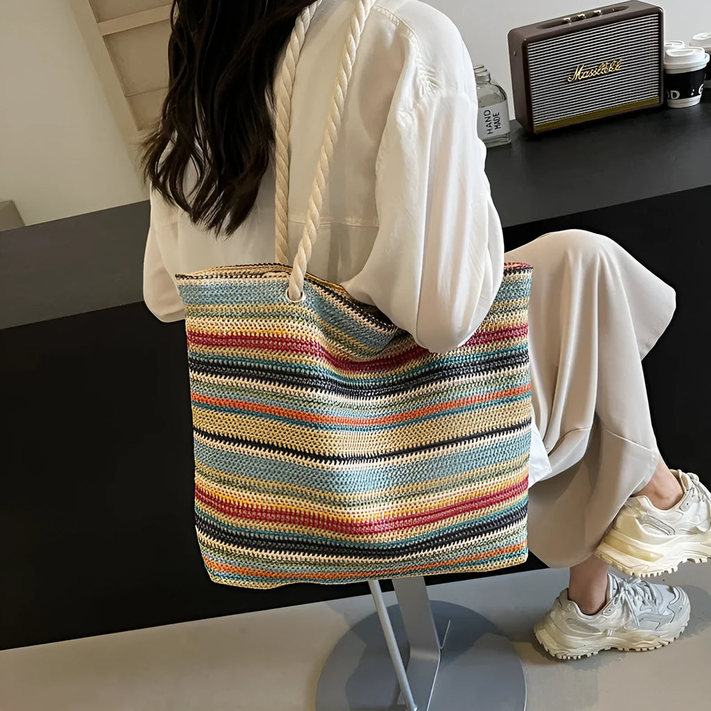 Blue nylon woven shoulder bag with large capacity and polyester lining shown against a neutral background