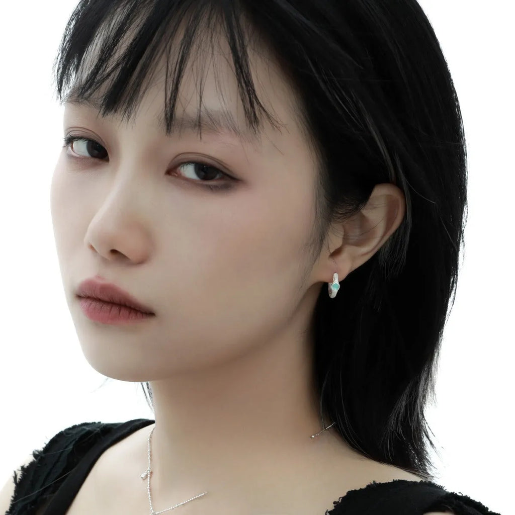 Geometric burnt silver ear clip for women, made from 925 sterling silver with a round design element.