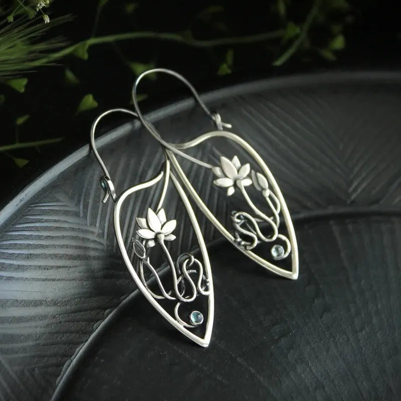 Silver lotus vine rhinestone earrings with geometric floral design