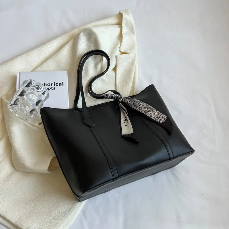 Large bucket-style tote bag with crossbody strap shown in multiple colour options
