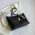 Large bucket-style tote bag with crossbody strap shown in multiple colour options