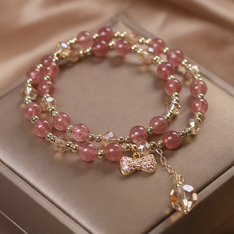 Double-layer strawberry quartz bracelet with lucky cat charm and red cat's eye flowers on adjustable fastening