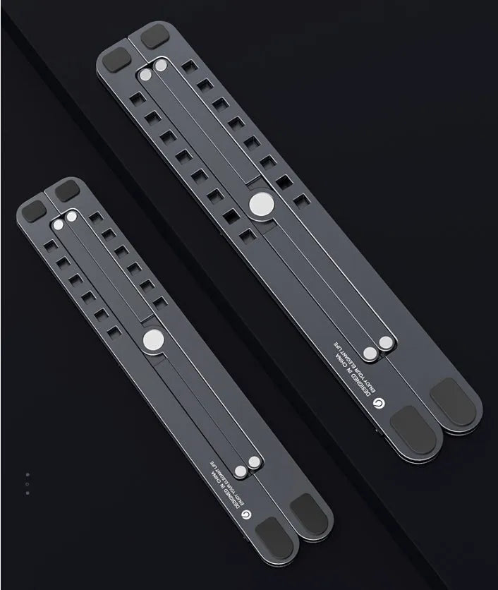 Aluminum alloy laptop stand in silver colour, folded to show its slim profile next to a 15-inch laptop.