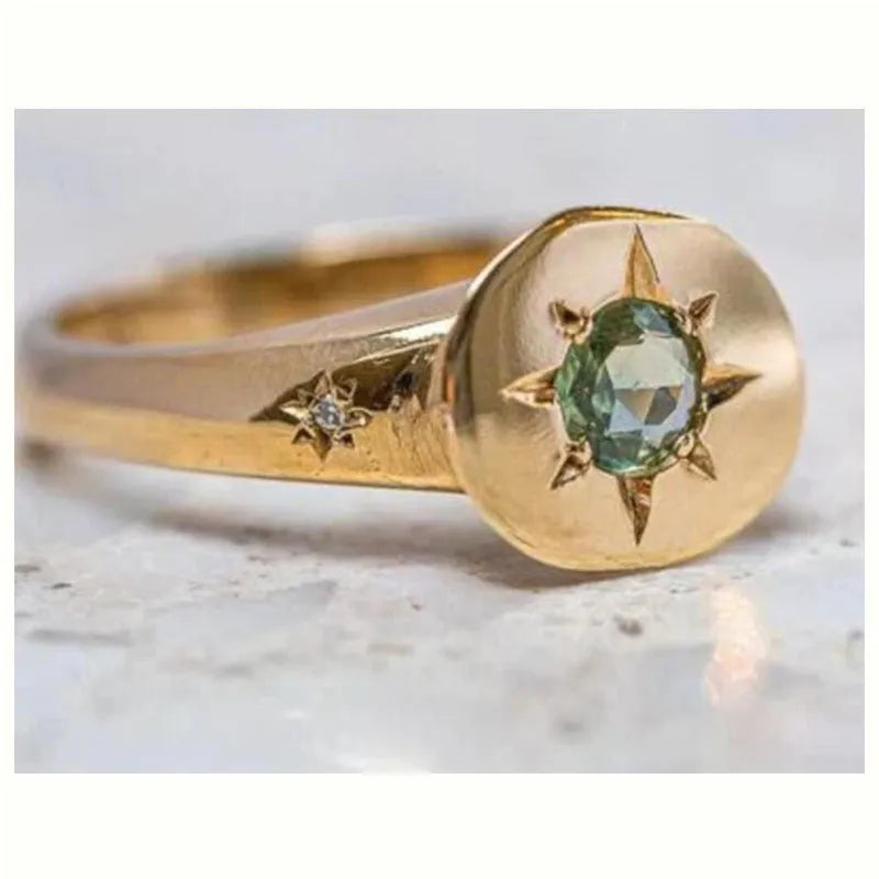 Gold-coloured star-shaped ring with oval zircon detail and adjustable opening