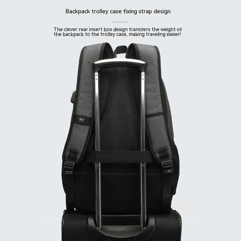Grey lightweight nylon backpack with USB charging port shown on a trolley suitcase.